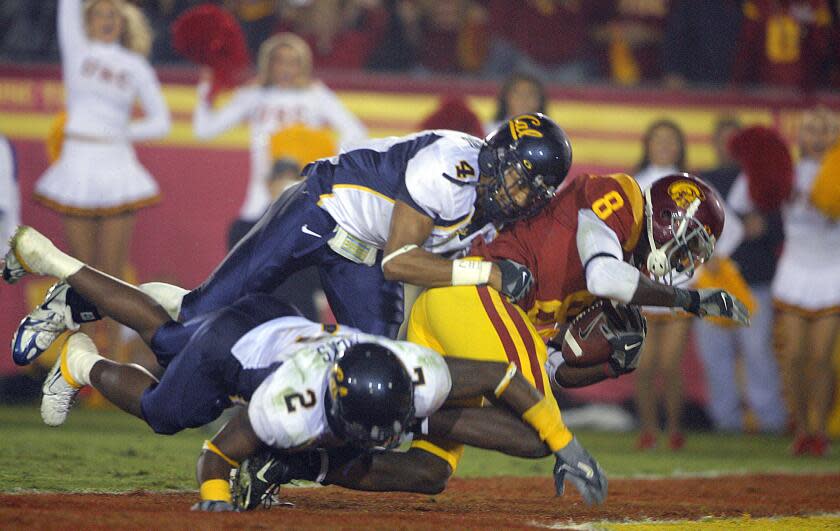 USC receiver Dwayne Jarrett scores a touchdown as he is tackled by California's Thomas DeCoud and Bernard Hicks