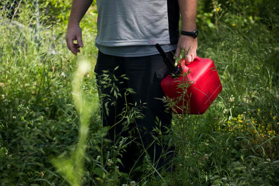 Environmental Technician Chris Winchester holds a can of decomposed grass in water, used as bait to catch mosquitos in a Gravid Trap, in Knoxville, Tuesday, May 21, 2019. KCHD regularly tests mosquitos in the city and county for disease throughout the warmer months.