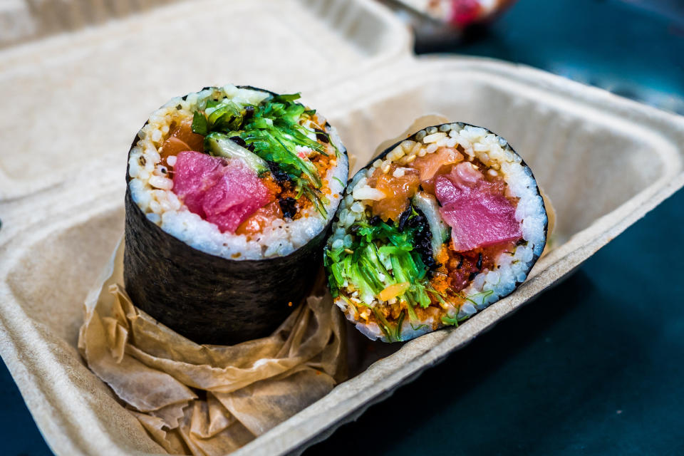 A sushi burrito sliced in half