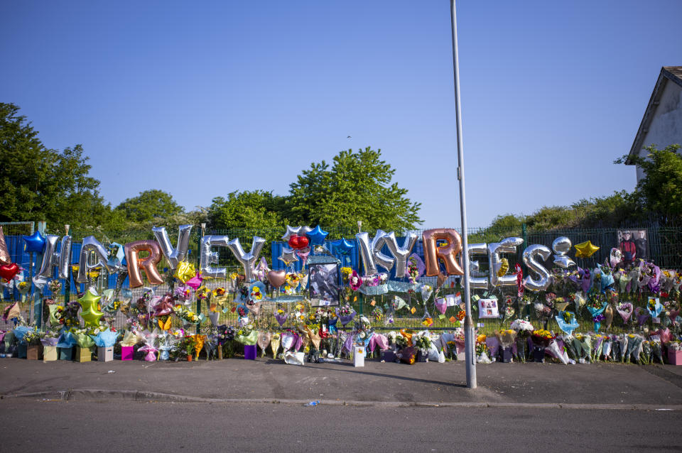 CARDIFF, WALES - MAY 25: Floral tributes to Kyrees Sullivan, 16, and Harvey Evans, 15, are seen on Snowden Road, Ely on May 25, 2023 in Cardiff, Wales. The two teenagers died in an electric bike crash in Cardiff. Their deaths sparked a riot in Ely which saw cars set alight. CCTV footage shows a police van following the bike moments before it crashed. (Photo by Matthew Horwood/Getty Images)