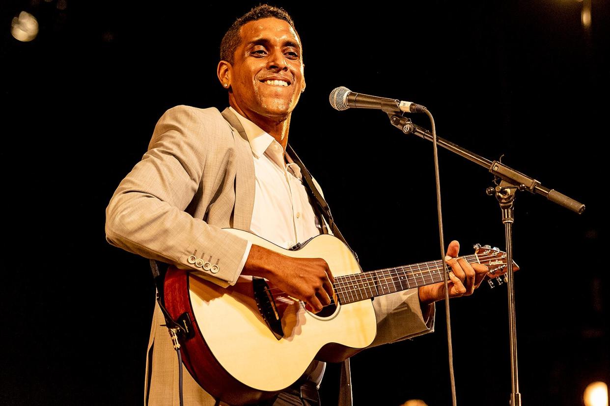 Haitian musician Mikaben (born Michael Benjamin) plays guitar as he performs (as a special guest with Emeline Michel & her band) during the World Music Institute's 'Eritaj' ('Heritage') concert, in celebration of Haitian Heritage Month, at Symphony Space, New York, New York, May 25, 2019.