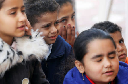 Christian children who left from Al-Arish city North Sinai’s Governorate capital after the escalation of a campaign targeting Christians by Islamic State militants last week, react during them prayer at a youth guest house in Ismailia, northeast of Cairo, Egypt February 27, 2017. Picture taken February 27, 2017. REUTERS/Amr Abdallah Dalsh