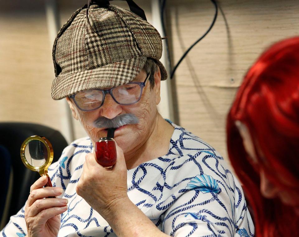 Sandra Morrison sports a costume mustache as "Detective Cloak Dagger" in "The Shadow of Peter Pan" at Alliance Health at Marina Bay in Quincy.