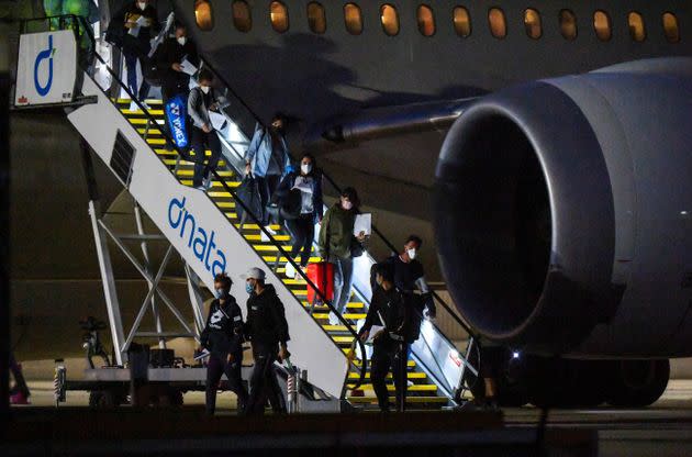 Tennis players and officials arrive on a charter flight in Melbourne on January 14, 2021, before quarantining for two weeks ahead of the Australian Open tennis tournament. 