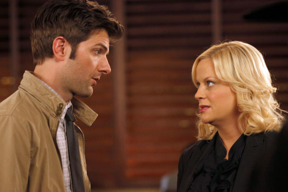 Adam and Amy looking at each other on Parks and Rec