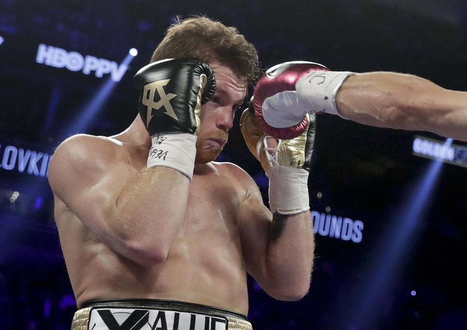 Canelo Alvarez dodges a jab from Gennady Golovkin during the second round of a middleweight title boxing match, Saturday, Sept. 15, 2018, in Las Vegas. (AP Photo/Isaac Brekken)