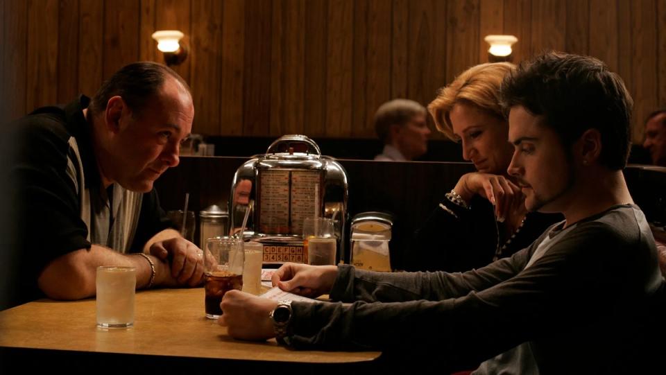 Tony Soprano sits on one side of a diner booth with Carmella and AJ on the other in the final scene of The Sopranos.