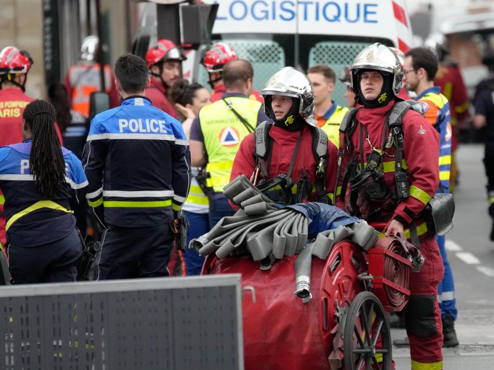 Police officers and rescue workers work at the scene of the blast (AP)