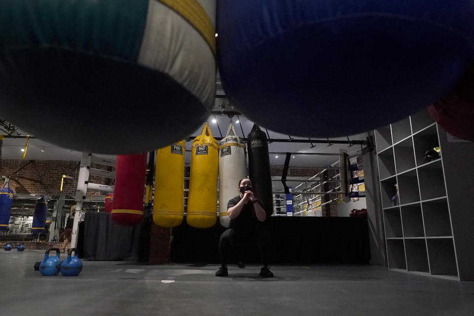 Tatyana Garrett wears a mask while working out in an indoor class at a Hit Fit SF gym amid the coronavirus outbreak in San Francisco, Tuesday, Nov. 24, 2020. (AP Photo/Jeff Chiu)