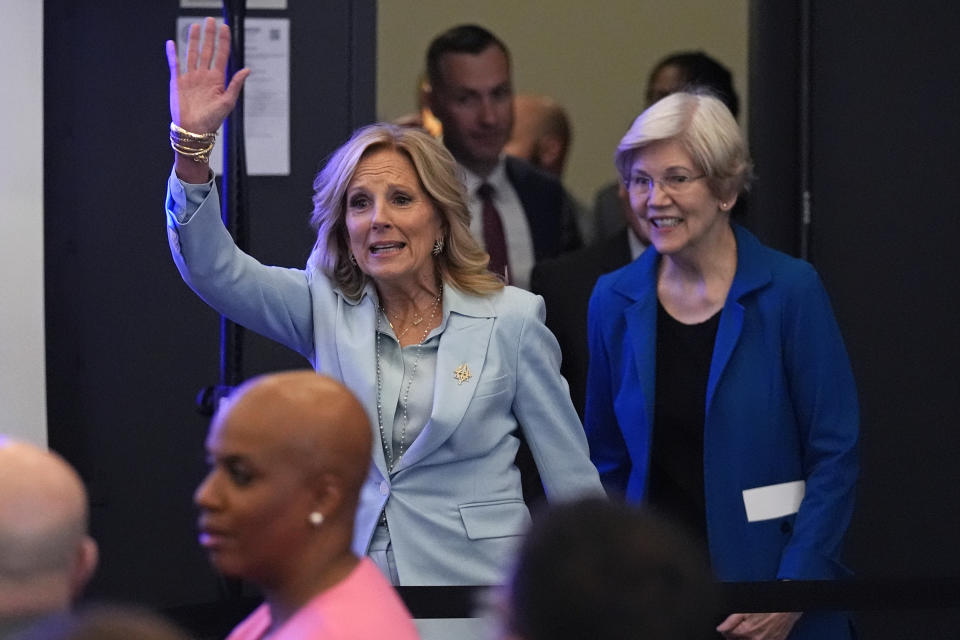 First lady Jill Biden, left, waves to guest while introduced with Sen. Elizabeth Warren, D-Mass., during a discussion on women's health research, Wednesday, Feb. 21, 2024, in Cambridge, Mass. (AP Photo/Charles Krupa, Pool)