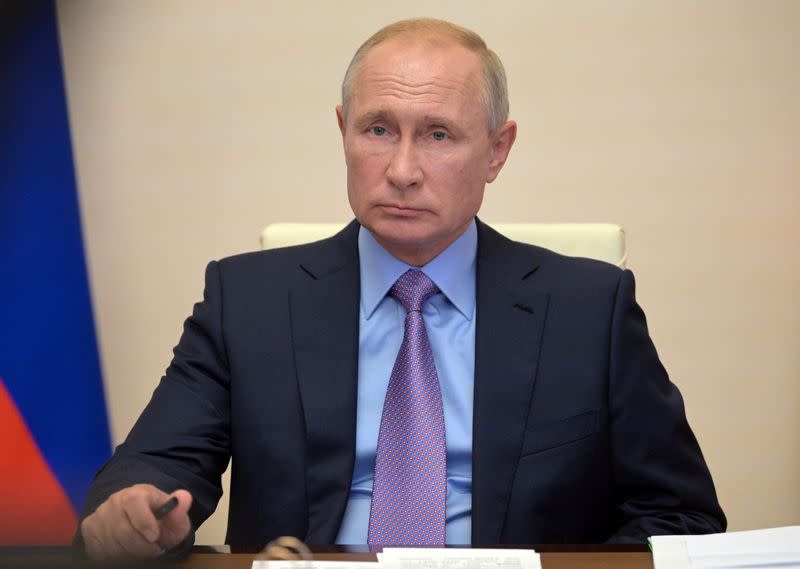 Russia's President Vladimir Putin takes part in a video conference call outside Moscow