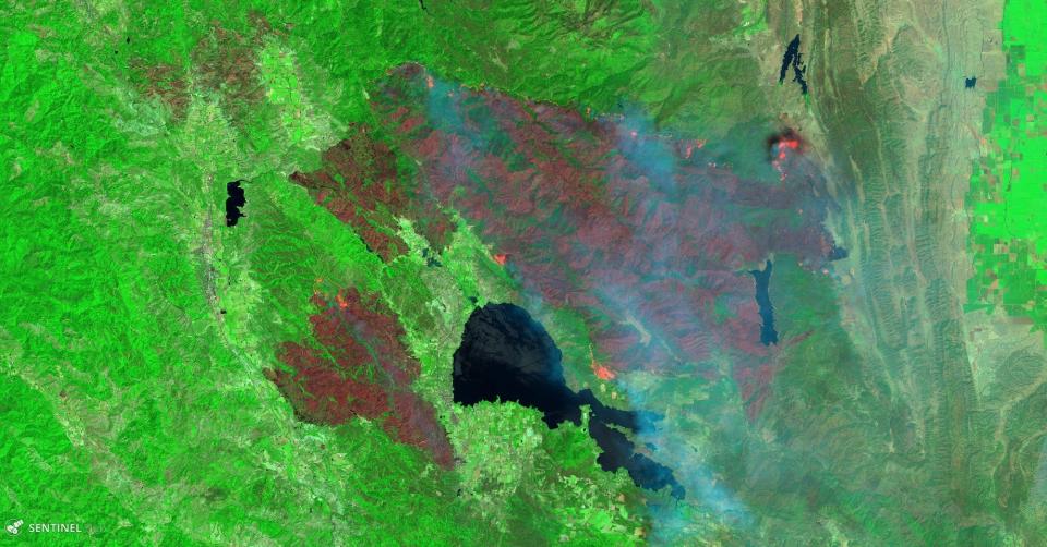 An image from the Sentinel satellite operated by the European Commission and European Space Agency captured on Aug. 6, 2018 shows green areas that are healthy vegetation, with the red showing burned areas. The orange areas indicate fire lines where the fire is spreading.