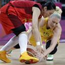 China's Song Xiaoyun, left, and Australia's Lauren Jackson, right, scramble for a loose ball during a quarterfinal women's basketball game at the 2012 Summer Olympics, Tuesday, Aug. 7, 2012, in London. (AP Photo/Eric Gay)