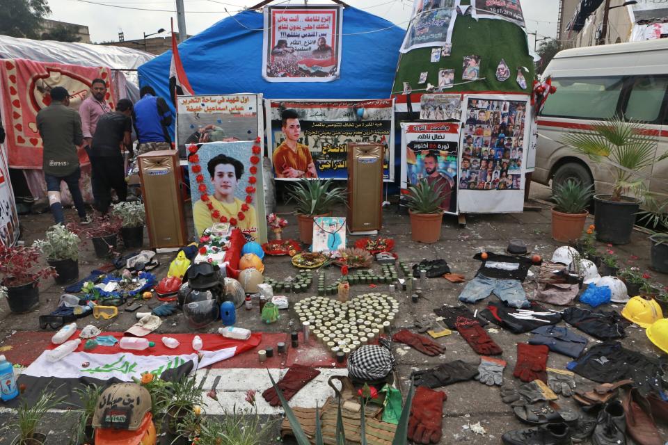 Posters of protesters who have been killed in demonstrations, their belongings, and protesters' slogans are displayed in Tahrir Square during ongoing anti-government protests in Baghdad, Iraq, Tuesday, Dec. 3, 2019. At least 400 people have died since the leaderless uprising shook Iraq on Oct. 1, with thousands of Iraqis taking to the streets in Baghdad and the predominantly Shiite southern Iraq decrying corruption, poor services, lack of jobs and calling for an end to the political system that was imposed after the 2003 U.S. invasion. (AP Photo/Hadi Mizban)