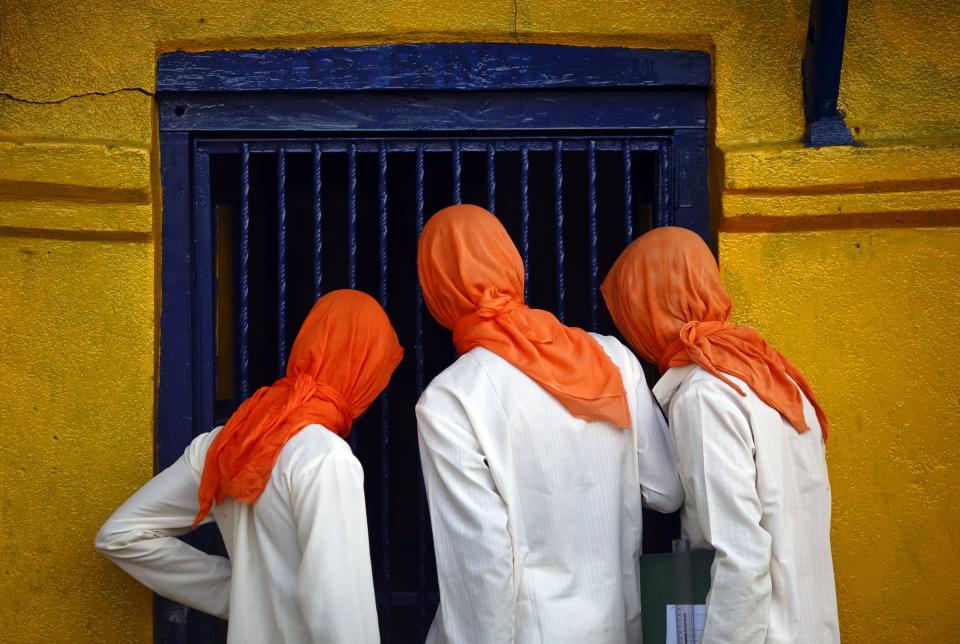 Hindu priests look inside a temple at the premises of Pashupatinath Temple in Kathmandu