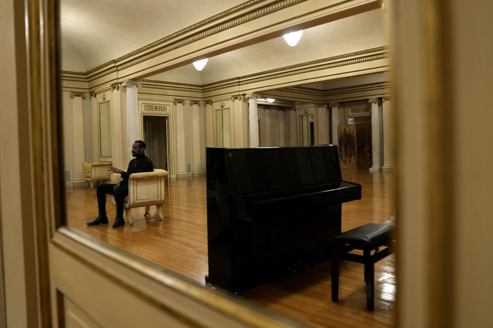 Composer Carlos Simon talks with journalist during an interview with The Associated Press prior to the start of the National Symphony Orchestra (NSO) concert at Milan's La Scala theatre, Italy, Monday, Feb. 26, 2024. (AP Photo/Antonio Calanni)