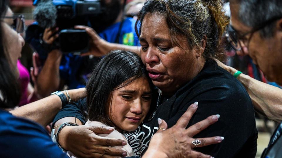 PHOTO: A woman hugs a girl as they cry during a vigil for the victims of the mass shooting at Robb Elementary School in Uvalde, Texas on May 25, 2022. (Chandan Khanna/AFP via Getty Images, FILE)
