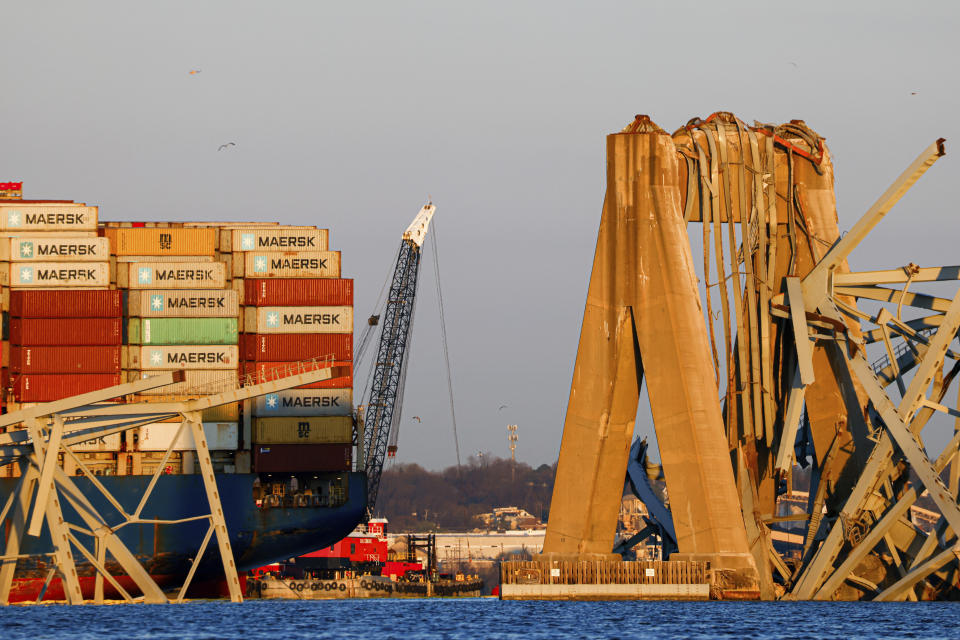 Cranes stand by as the wreckage of the Francis Scott Key Bridge rests on the container ship Dali, Saturday, March 30, 2024, in Baltimore. (AP Photo/Julia Nikhinson)