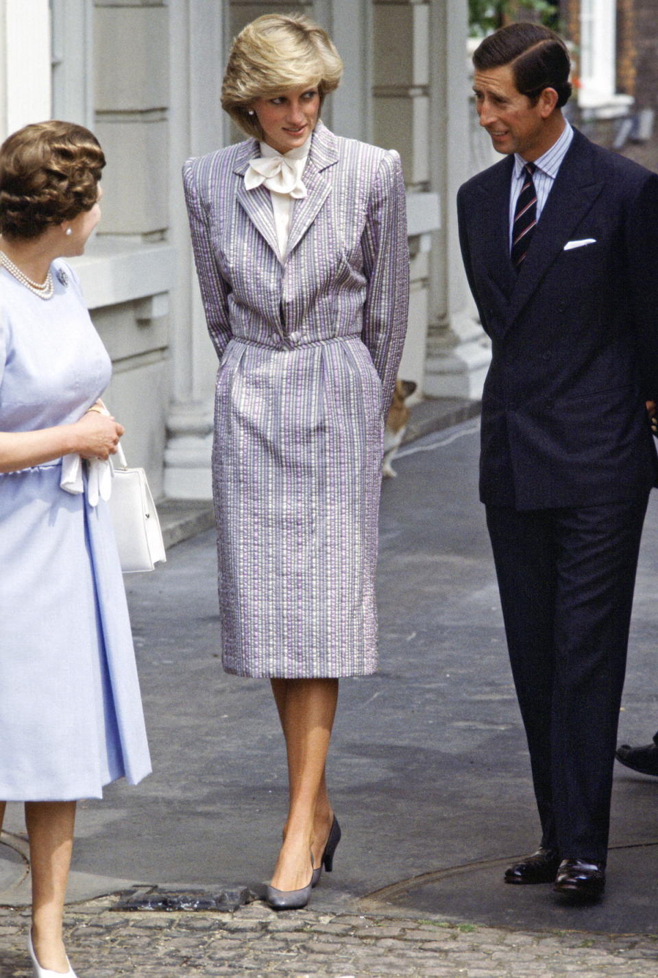 <p>During Diana’s lifetime, more and more women joined the workforce, and they struggled with workplace-appropriate attire. Diana gave them guidance with a series of menswear-inspired suit-dresses, like this early version, by designer Bruce Oldfield. (Photo: Tim Graham/Getty Images) </p>