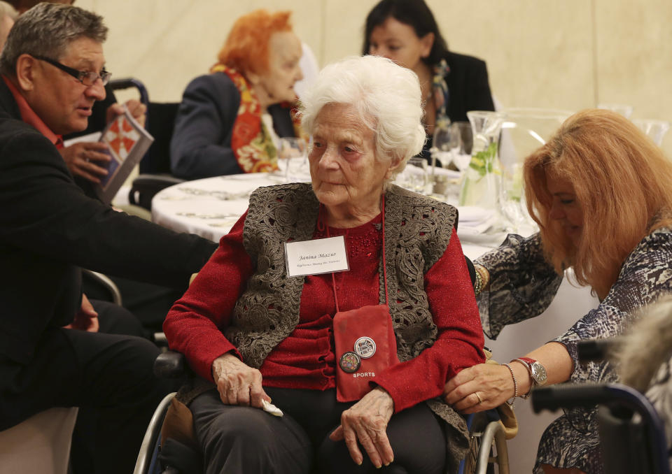 Janine Mazur, center, listens to speeches during an event to honor Polish people who saved Jews during WWII, in Warsaw, Poland, Sunday, Sept. 8, 2019. A U.S.-based Jewish foundation held an event in Warsaw on Sunday to honor Polish gentiles who rescued Jews during the Holocaust, a number that grows smaller each year, with U.S. and Israeli diplomats also paying their respects to the elderly Poles who put their lives in danger to save others. (AP Photo/Czarek Sokolowski)
