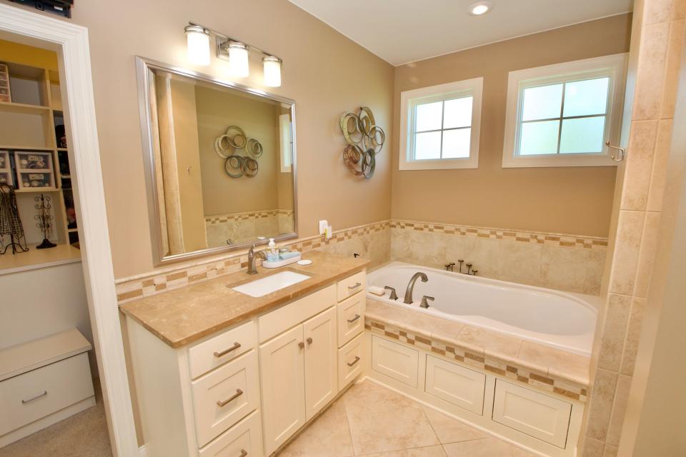 The en suite offers dual vanities and a Euro shower with multiple shower heads as well as a soaking tub.