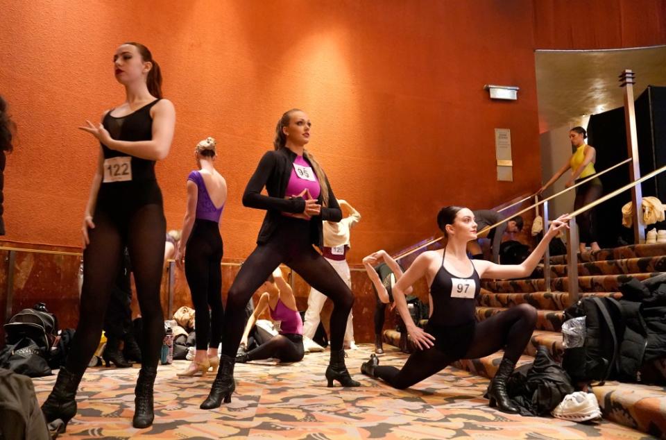 Dancers warm up and stretch in the lobby of the Radio City Music Hall. AFP via Getty Images