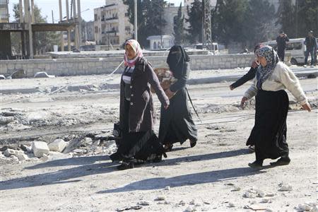 People flee the violence with their belongings in Masaken Hanano in Aleppo February 8, 2014. REUTERS/Hosam Katan