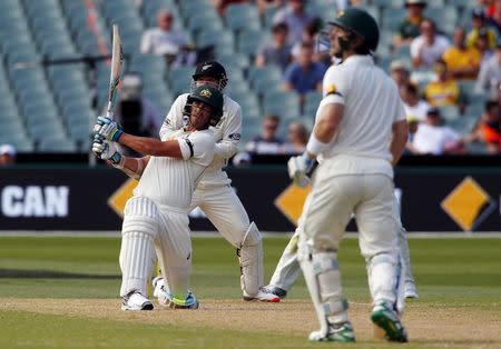 Australia's Peter Nevill (R) watches as team mate Mitchell Starc, who is suffering an injury to his right foot, hits a six during the second day of the third cricket test match against New Zealand at the Adelaide Oval, in South Australia, November 28, 2015. REUTERS/David Gray
