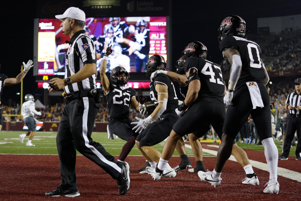 Minnesota players celebrate after blocking an Eastern Michigan punt for a safety during the second half of an NCAA college football game Saturday, Sept. 9, 2023, in Minneapolis. (AP Photo/Abbie Parr)