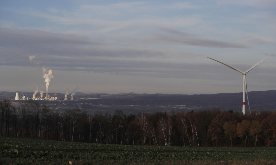 Smoke rises from chimneys of the Turow power plant located by the Turow lignite coal mine near the town of Bogatynia, Poland, Tuesday, Nov. 19, 2019. The Turow lignite coal mine in Poland has an impact on the environment and communities near the border of three neighboring countries, the Czech Republic, Germany and Poland. Plans to further expand the huge open pit mine have caused alarm among residents who fear things might get even worse. (AP Photo/Petr David Josek)