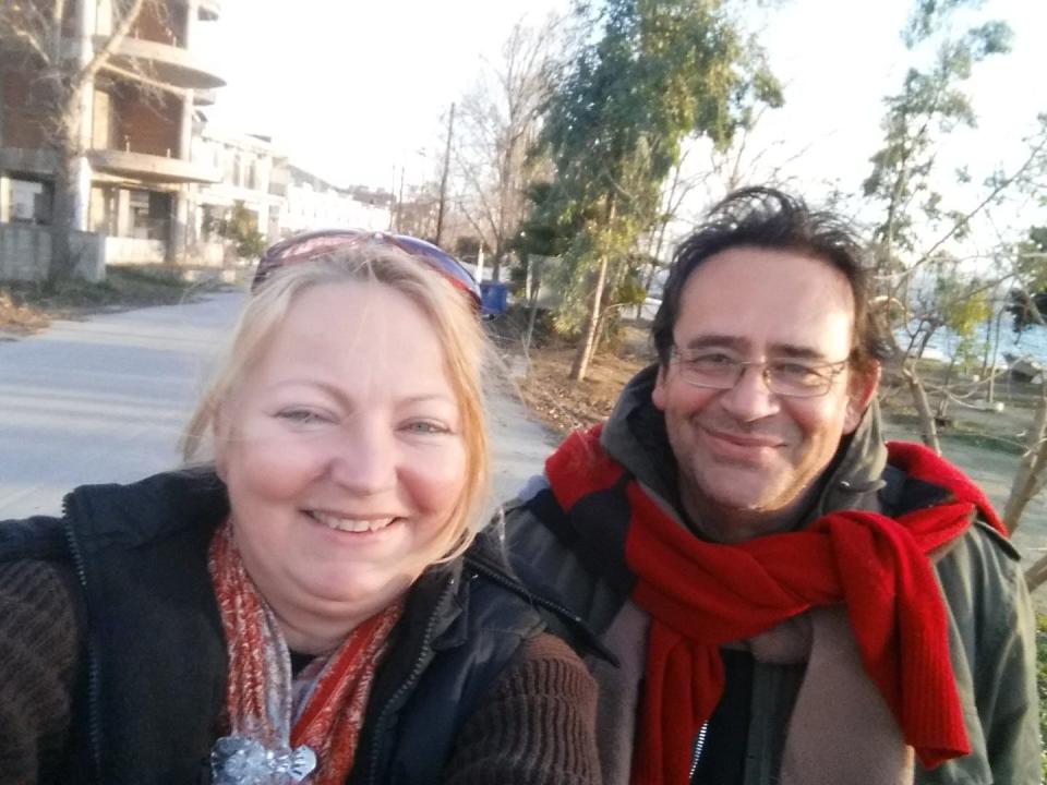 A woman and a man taking a picture wearing winter clothes.