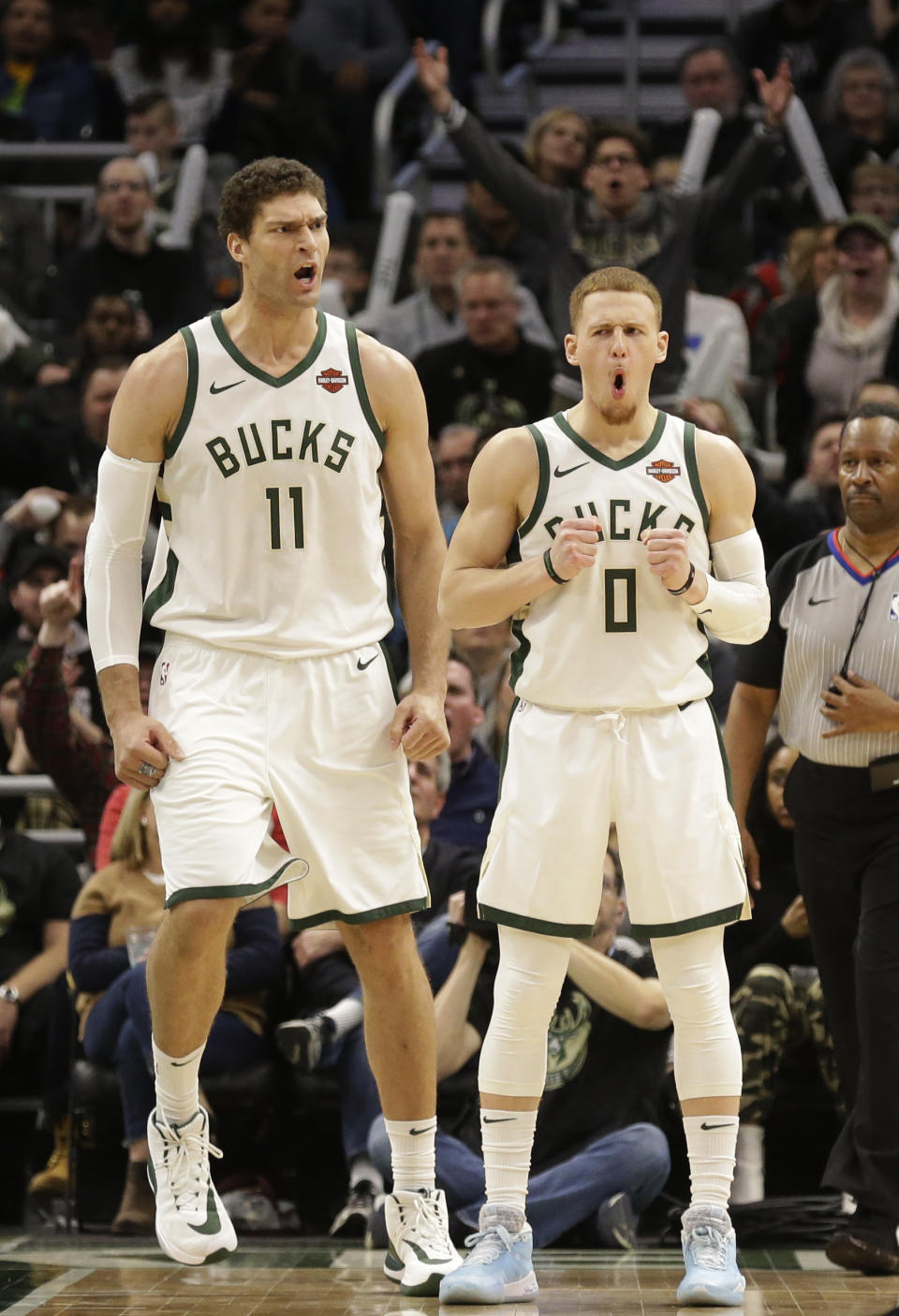 Milwaukee Bucks' Brook Lopez (11) and Donte DiVincenzo react to a foul called on Lopez during the second half of an NBA basketball game against the Minnesota Timberwolves on Wednesday, Jan. 1, 2020, in Milwaukee. The Bucks won 106-104. (AP Photo/Jeffrey Phelps)