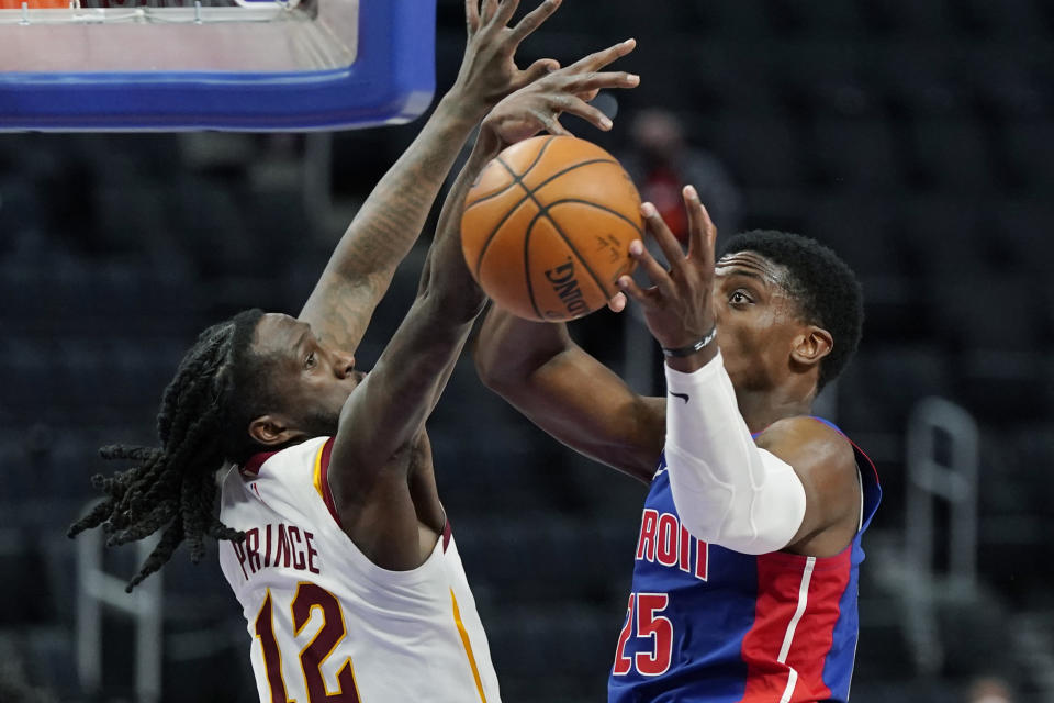 Cleveland Cavaliers forward Taurean Prince (12) knocks the ball away from Detroit Pistons forward Tyler Cook (25) during the second half of an NBA basketball game, Monday, April 19, 2021, in Detroit. (AP Photo/Carlos Osorio)