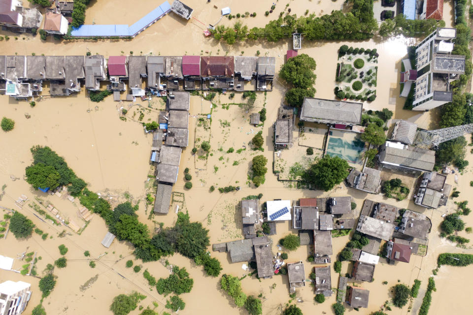 In this aerial photo released by Xinhua News Agency, a village is flooded in Sanjiao Township of the Yongxiu County in eastern China's Jiangxi Province Monday, July 13, 2020. Chinese authorities forecasted heavy rain across a wide swath of the country prompting evacuation of residents and raising emergency alerts levels. (Zhang Haobo/Xinhua via AP)