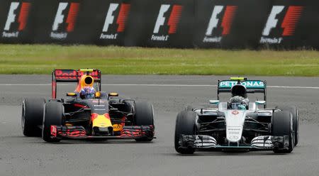 Britain Formula One - F1 - British Grand Prix 2016 - Silverstone, England - 10/7/16 Red Bull's Max Verstappen and Mercedes' Nico Rosberg during the race REUTERS/Andrew Boyers Livepic