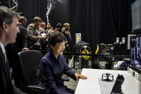 South Korea’s President Park Geun-hye is given instructions in the control of a robotic arm as she tours NASA's Goddard Space Flight Center in Greenbelt, Maryland October 14, 2015. REUTERS/James Lawler Duggan