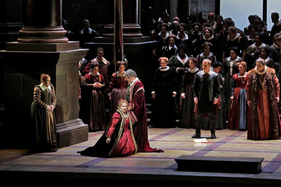 In this March 11, 2013 photo provided by the Metropolitan Opera, Krassimira Stoyanova kneels in the role of Desdemona opposite Jose Cura in the title role during a performance of of Verdi's "Otello," at the Metropolitan Opera in New York. (AP Photo/Ken Howard)
