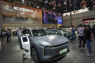 Visitors look at an Exeed C-DM car during the China Auto Show in Beijing, China, Friday, April 26, 2024. China's vision of the future of the automobile electrified and digitally connected is on display at the ongoing Beijing auto show. (AP Photo/Tatan Syuflana)