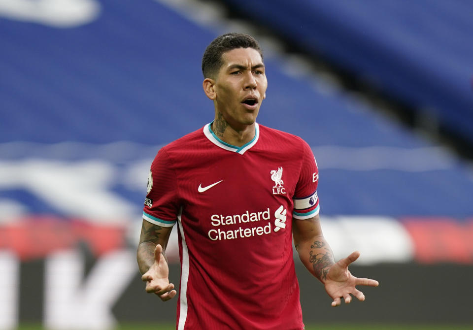 Liverpool's Roberto Firmino reacts after missing a chance to score during the English Premier League soccer match between West Bromwich Albion and Liverpool at the Hawthorns stadium in West Bromwich, England, Sunday, May 16, 2021. (Tim Keeton/Pool via AP)