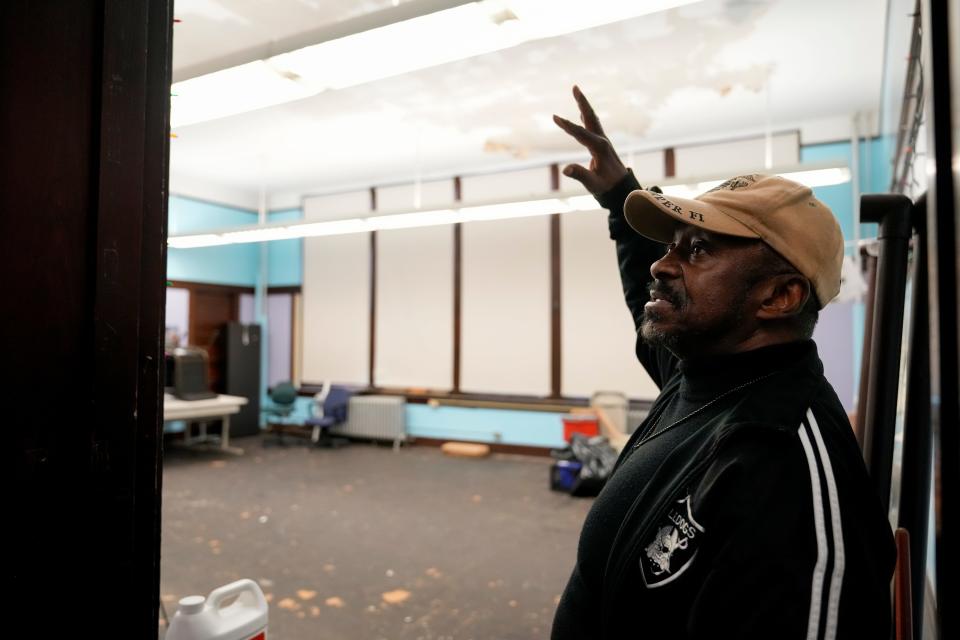 The Rev. Peterson Mingo describes the extent of water damage inside the building at the former Hoffman School on Durrell Avenue in the Evanston neighborhood of Cincinnati on Tuesday, March 21, 2023. The Christ Temple Baptist Church currently resides in the building, but church leader, pastor Peterson Mingo, and the congregation have said the maintenance and repairs required to keep the building safe and operational are beyond their means.