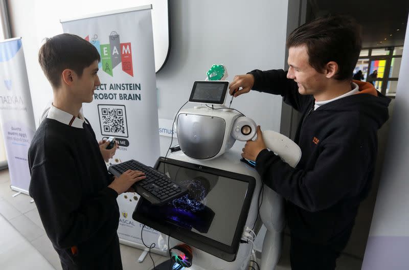 High school students Richard Erkhov and Vladimir Baranov work on "Alnstein", a robot powered with ChatGPT, in Pascal school in Nicosia