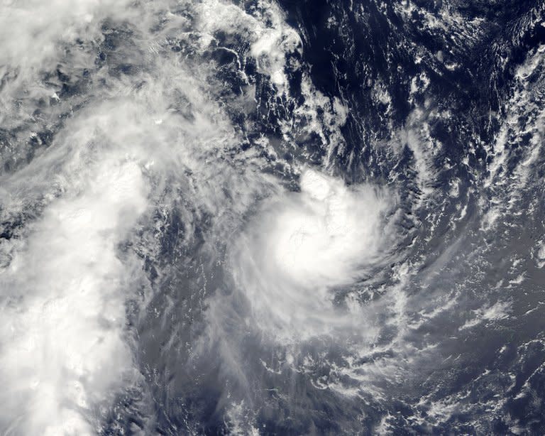 Tropical Cyclone Evan is photographed by NASA's Aqua satellite on December 13, 2012 as it passes over Samoa. Authorities scrambled to evacuate tourists and residents in low-lying areas Sunday as a monster cyclone threatened Fiji with "catastrophic damage"