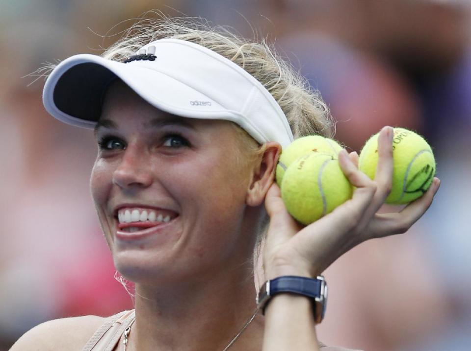 Caroline Wozniacki plays to the crowd after defeating Maria Sharapova Sunday. (AP Photo/Kathy Willens)