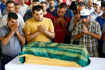 Family members of Sehriban Nurbay, a 3-month-old victim of a suicide bombing at a wedding in Gaziantep, attend her funeral ceremony in the southern Turkish city of Gaziantep, Turkey, August 21, 2016. REUTERS/Osman Orsal