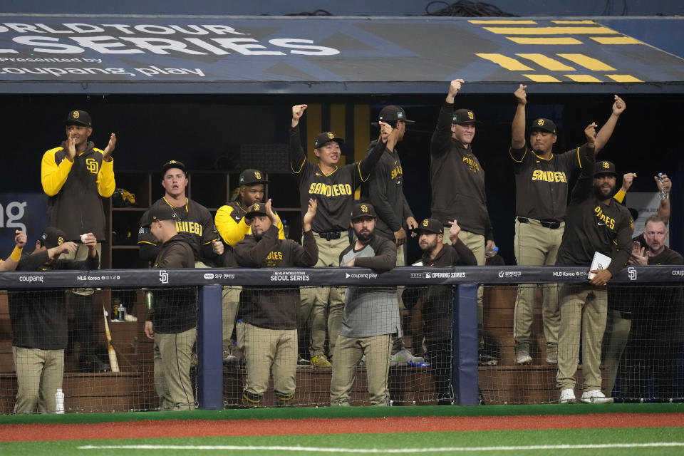 Members of the San Diego Padres cheer from the dugout after Jake Cronenworth hit an RBI triple during the first inning of a baseball game against the Los Angeles Dodgers at the Gocheok Sky Dome in Seoul, South Korea Thursday, March 21, 2024, in Seoul, South Korea. (AP Photo/Lee Jin-man)