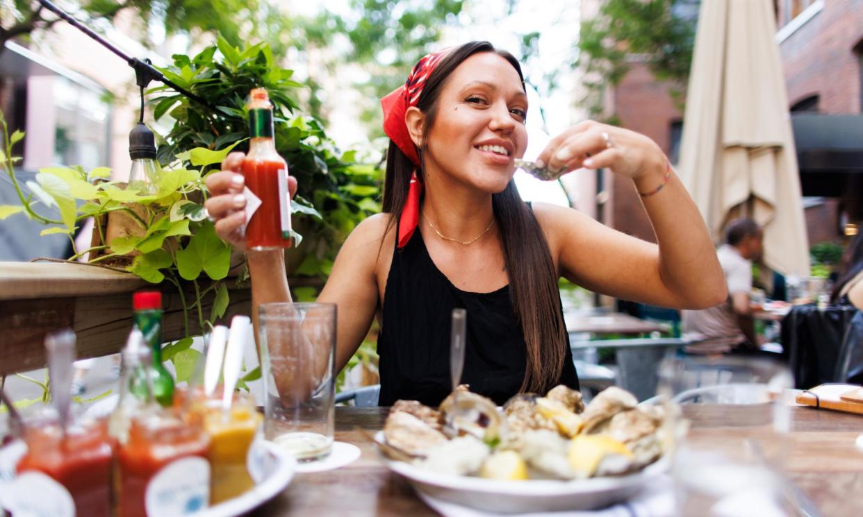 <span>Alex Karol, who describes herself as a bivalve vegan, enjoying a meal at Rodney’s Oyster House in Toronto, Canada. </span><span>Photograph: Cole Burston/The Guardian</span>