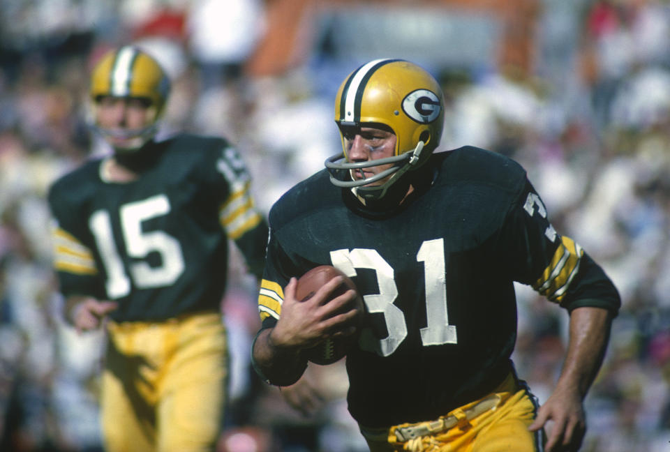 Green Bay Packers fullback Jim Taylor carries the ball during a 1965 game at Lambeau Field. Taylor died Saturday at the age of 83. (Getty)