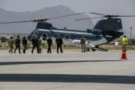 Secretary of State Mike Pompeo, third from right in suit, walks to board a helicopter upon arrival in Kabul, Afghanistan, Tuesday, June 25, 2019, during an unannounced stop. (AP Photo/Jacquelyn Martin, Pool)