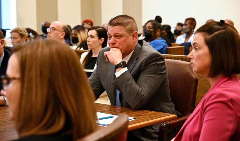 Former Kansas City police detective Eric DeValkenaere, center, became emotional as he listened to his father, Albert DeValkenaere, give a statement during his sentencing hearing Friday, May 4, 2022. Seated near DeValkenaere were attorneys Dawn Parsons, left, and Molly Hastings. DeValkenaere was sentenced to six years in the Dec. 3, 2019, killing of Cameron Lamb.