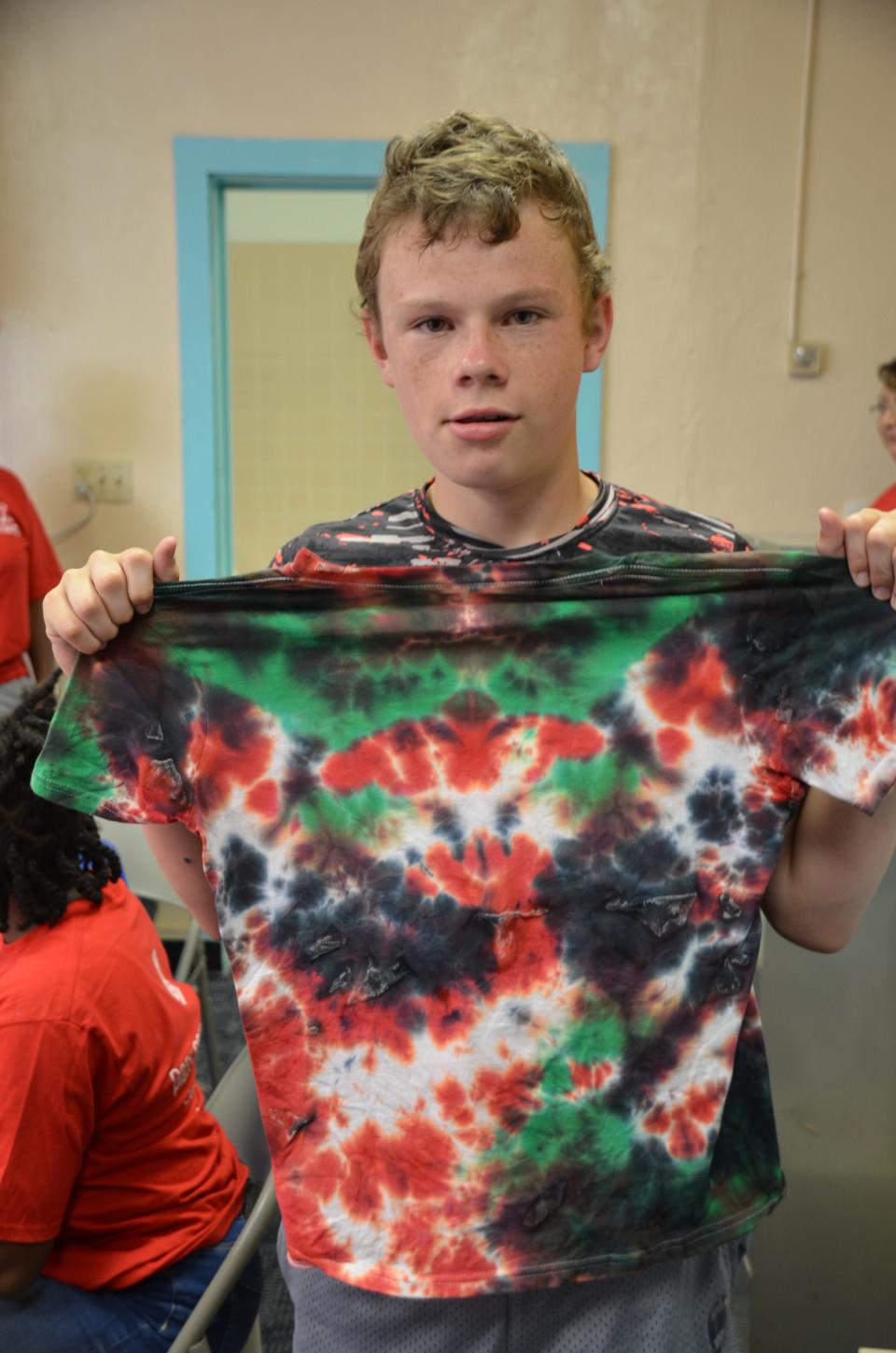 Austyn Lamb making a tie dye tee at the Healing Hearts Grief Camp on Thursday, June 22